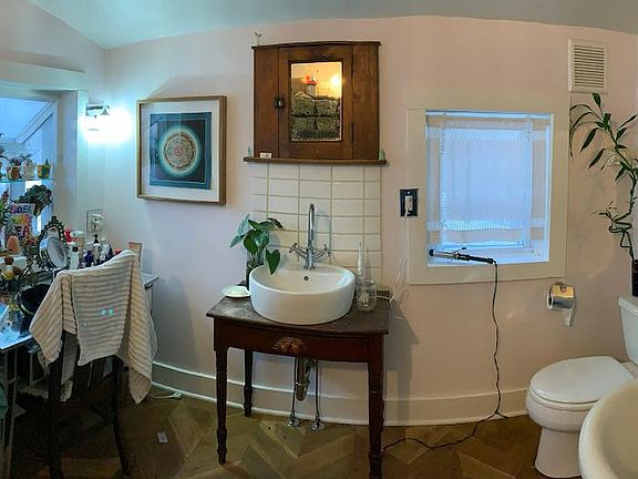 Bathroom; new washer /dryer, garden window, hard wood herringbone floors, and clawfoot tub / shower.