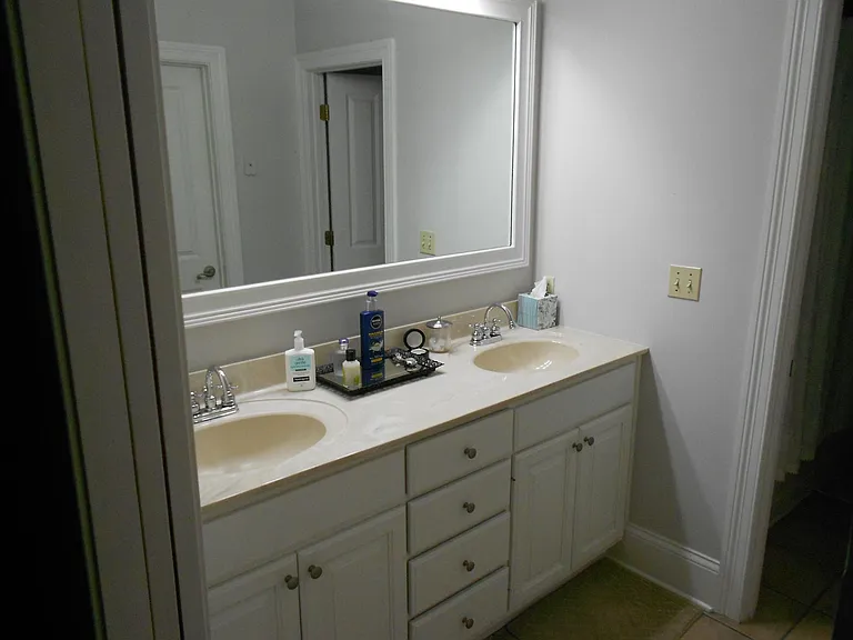 Master bath with dual sinks and two closets.