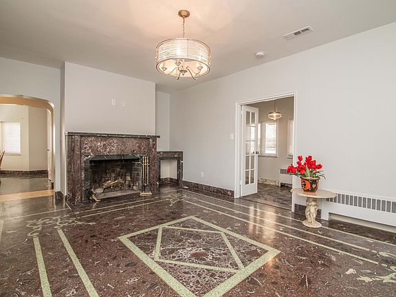 formal living room with marble fireplace