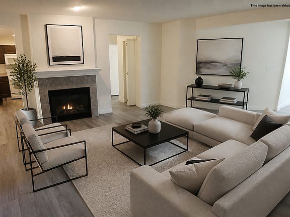 Living Room with gas fireplace, virtually staged
