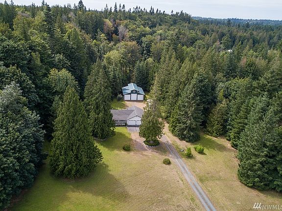 Level & Private acreage surrounded by evergreens.