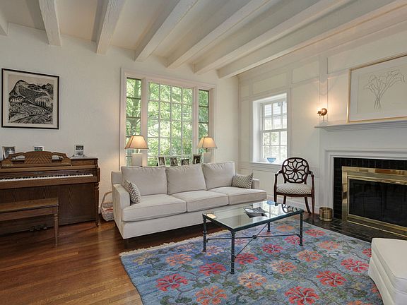 Over-sized window, beamed ceiling & wood burning fireplace