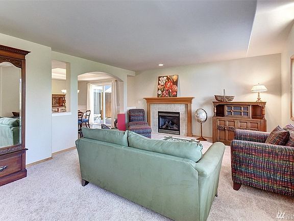 Space between living room is defined by an arched doorway and window like openings. 