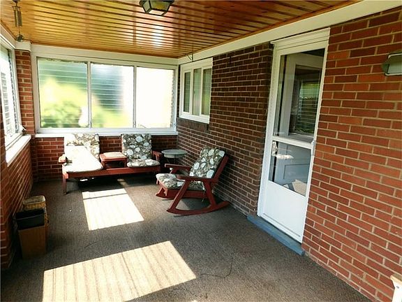 Check out the enormous covered back patio. It is surrounded by jalousie windows. They can be opened 