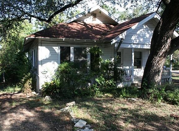Along the left side of the house, a driveway lies on the property line. Could you place a garage in the back with an apartment above for additional income?