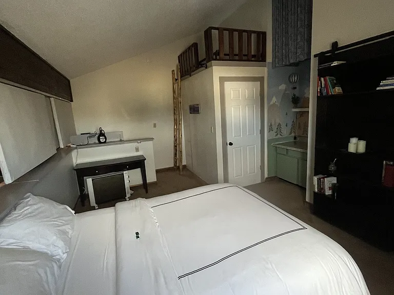 There is space to store things above the closet or behind the blue curtains. A twin bed that is currently stored but has been used in the room next to the queen bed. Lots of space upstairs!