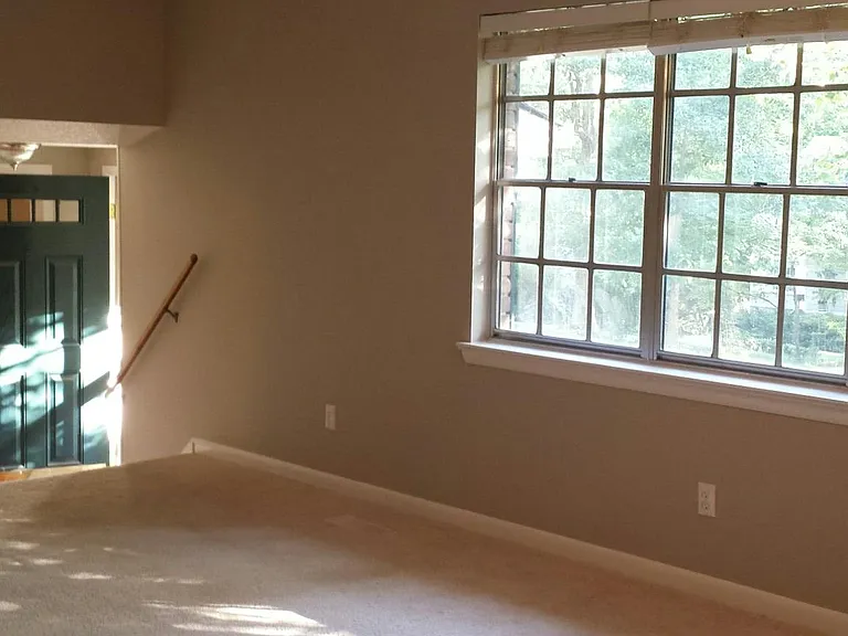 living/dining room with updated window looking toward front door