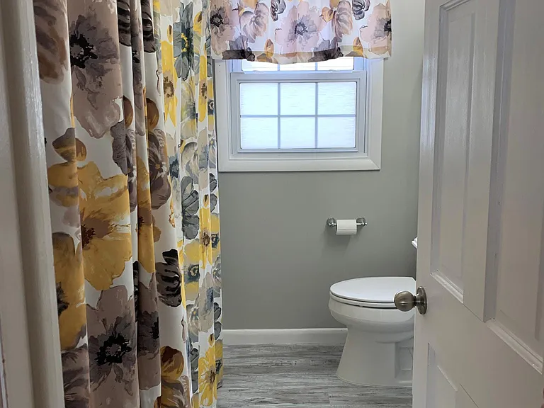 1st floor full bathroom with linen closet & new vinyl flooring