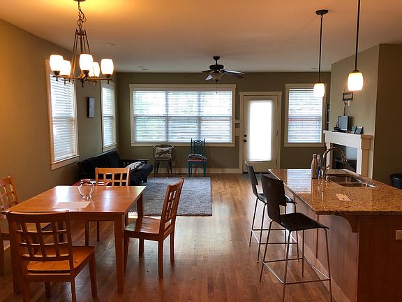 Kitchen, dining, and second living room with fireplace overl