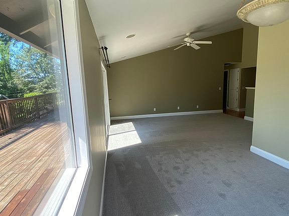 Light filled living room sliding door access to full length of home deck
