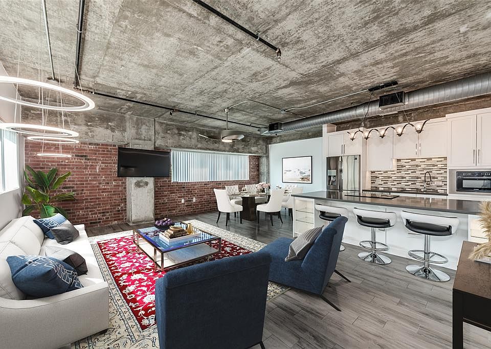 Architectural elements create a true loft feel. Exposed brick wall, exposed duct work, and concrete ceilings. This is a virtually staged photograph. Total Kitchen remodel with Samsung appliances. Notice the designer lighting!