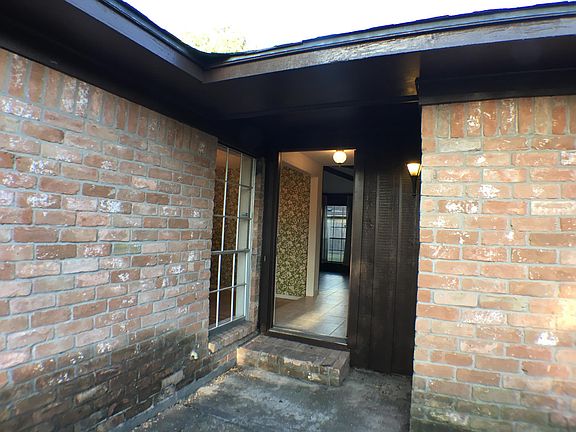 The front door, formal dining room on the left, living room in the middle, and the bedrooms on the right.