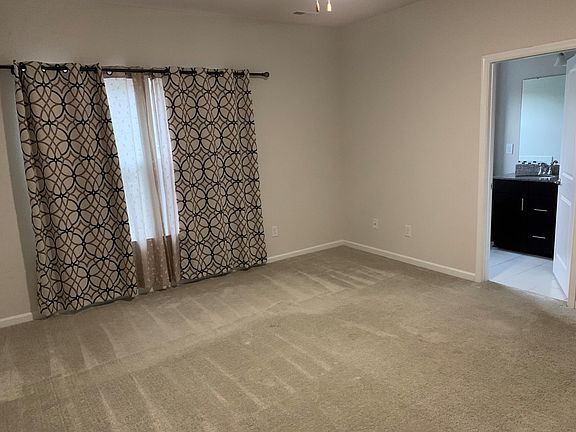 Large master bedroom with walk-in closet and attached bath