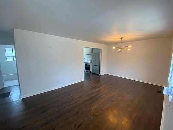 Open concept Living room with accent wall for flatscreen and dining area