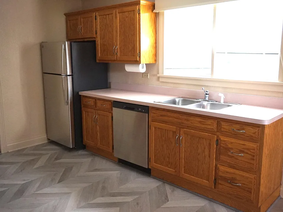 Spacious eat in kitchen with new stainless steel appliances and a diswasher.