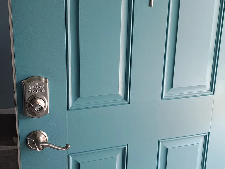 Front door to condo with electronic entry lock for key less entry.