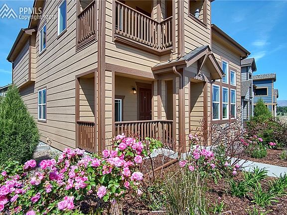 Front with covered front porch and covered upper balcony