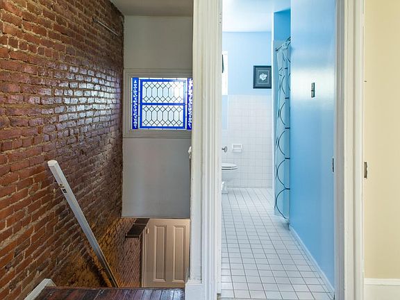 Stairs and bathroom, exposed brick and stained glass