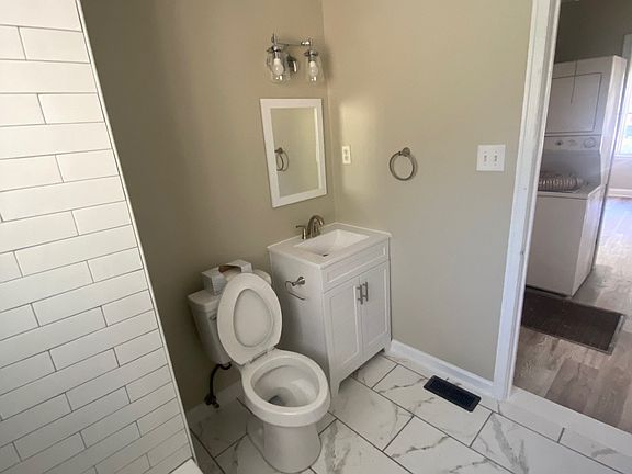 bathroom, with w/d in hallway in background