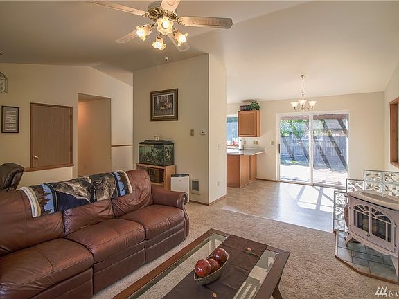 Another look from the living room toward the dining & kitchen. Sliding glass doors leading to the rear deck. Front entry to the left. Great propane stove for added heat during the chilly months!