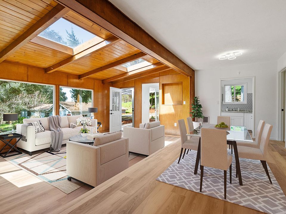 Great room and dining room areas. Huge windows and sky lights for beautiful natural light and that indoor-outdoor living feel, side door accesses front patio