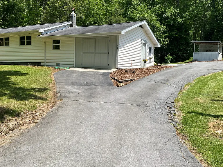 Paved driveway and parking at the storage/work shop area.