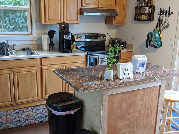 Kitchen with slider door to deck and fenced backyard. Laundry in kitchen closet.