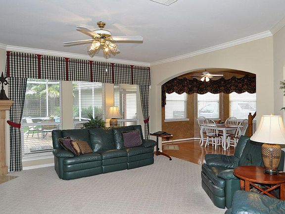 Open family room with panoramic window overlooking back yard and porch area.