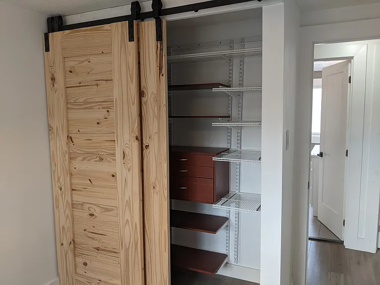 Master Bedroom includes closet organizer and barn door access to free up floor space.