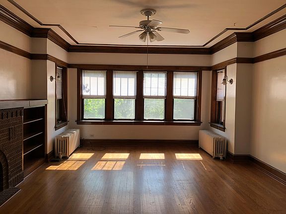 Living room with built-ins and east-facing windows.