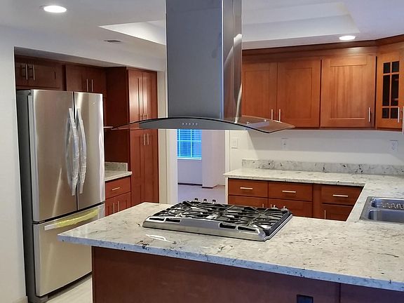 Stainless steel appliances, cherry cabinets and granite coun