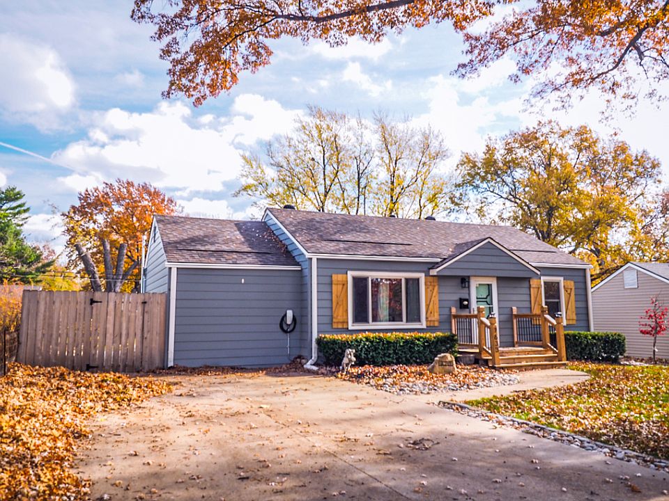 front of home with four car driveway and tesla charger