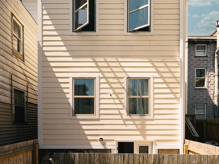 Back view of building with private backyard