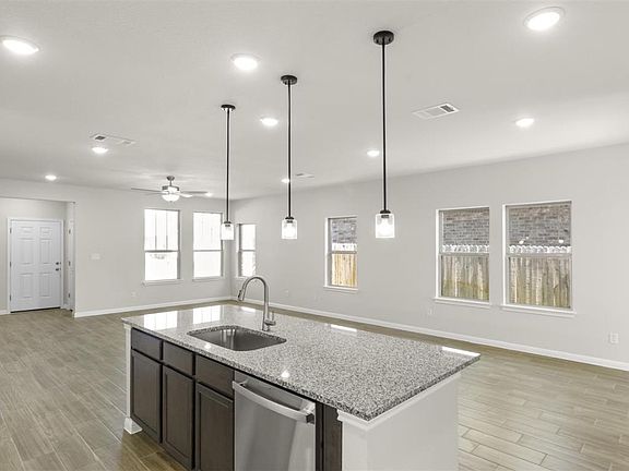 16_Kitchen with open floor plan, a ceiling fan, visible vents, stainless steel dishwasher, and a sin