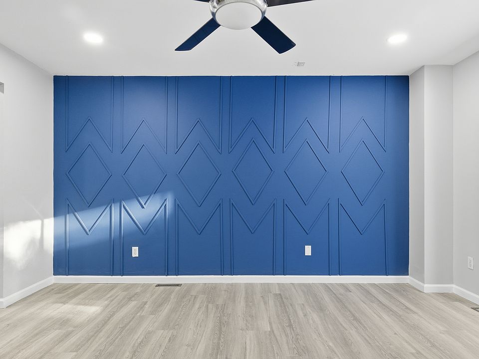 Stunning custom accent wall adds a modern designer touch to this flexible family/dining room_perfect for entertaining or a second living space