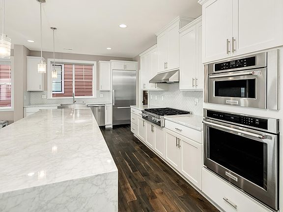 Luxury kitchen with Miele appliances and slab marble island