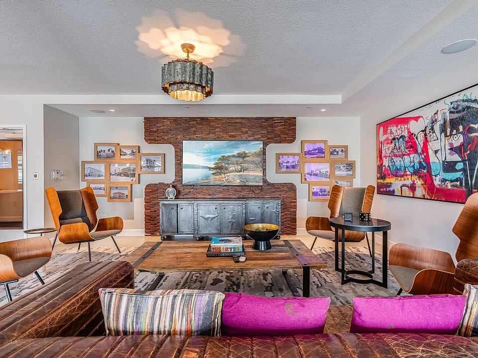 Clubroom Lounge Area with Leather Sofas, Framed Art, and Mounted TV