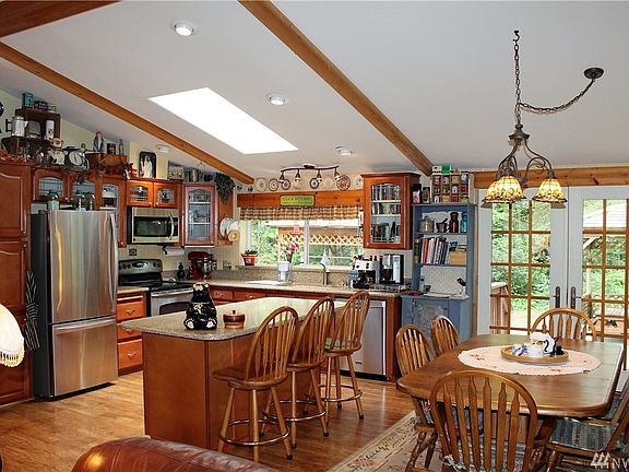 The kitchen and dining part of the great room - nice stainless appliances, newer Quartz counter tops, French doors leading to the back patio and two gazebos (with a hot tub!).