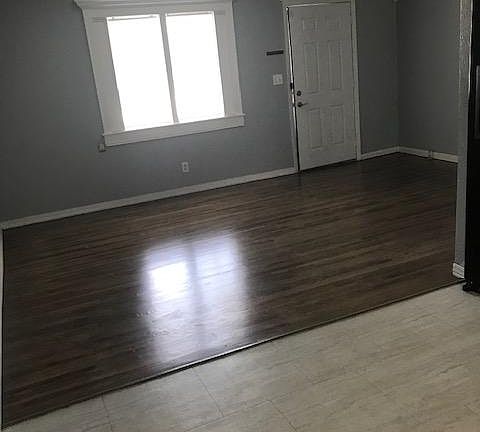 Open living room to kitchen with beautiful wood floors.