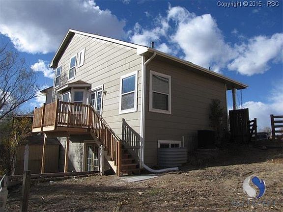 View of the home from the back yard, showing the new deck.
