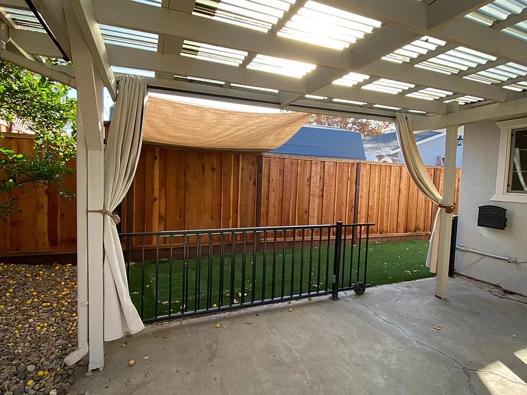 backyard with turf on the side.