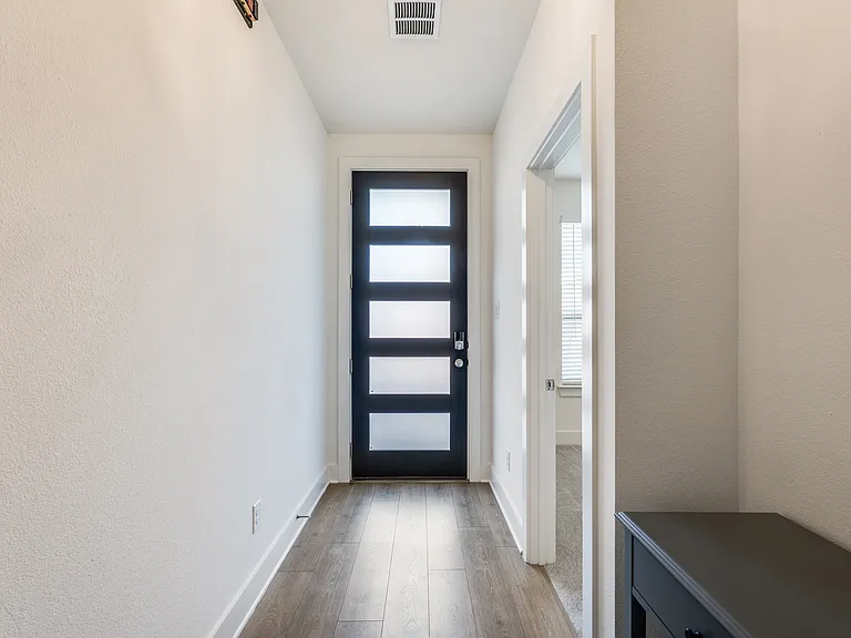 Front door and hallway from interior.