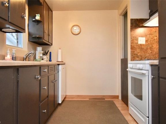 The galley kitchen includes an entrance from the breezeway with access to the basement.