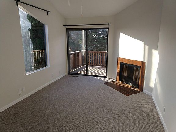 Upstairs bedroom with fireplace and deck. Will have engineered hardwood flooring prior to move in