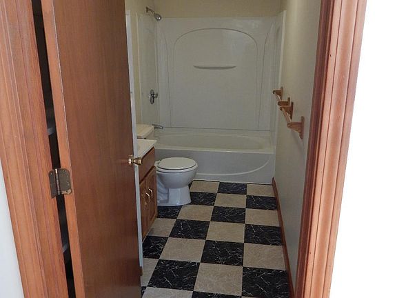 Bathroom with spacious storage shelves behind the door.