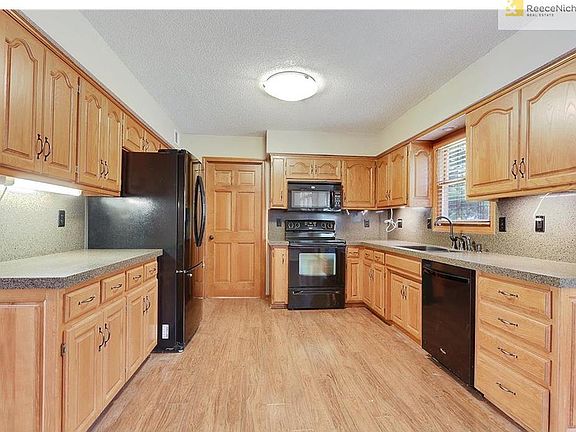 Kitchen has ample space.  Door to the back leads to a bathroom and a nice size laundry room.  To the left is access to the dining room and to the right is a breakfast area and access to the backyard.