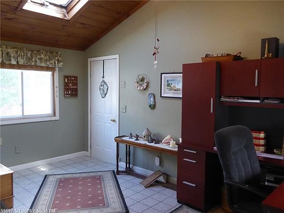 Entrance from the attached garage doubles as a mudroom and office, with tile floor and skylight.