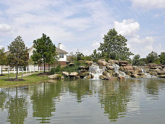 This is the home view looking from one of three ponds surrounding the home.
