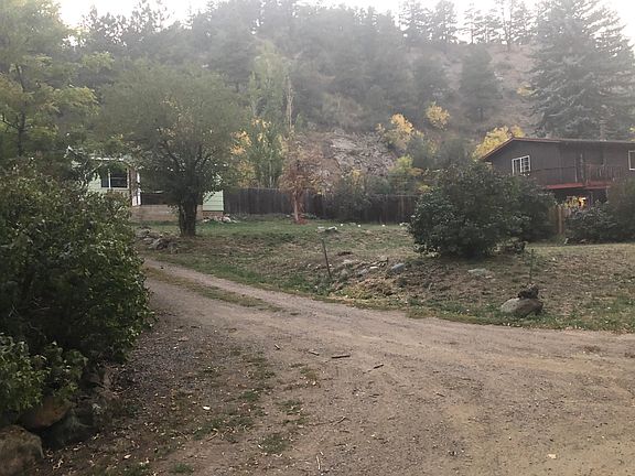 View from the bottom of the driveway looking towards the cabin. The neighbor's house is the brown house on the right.