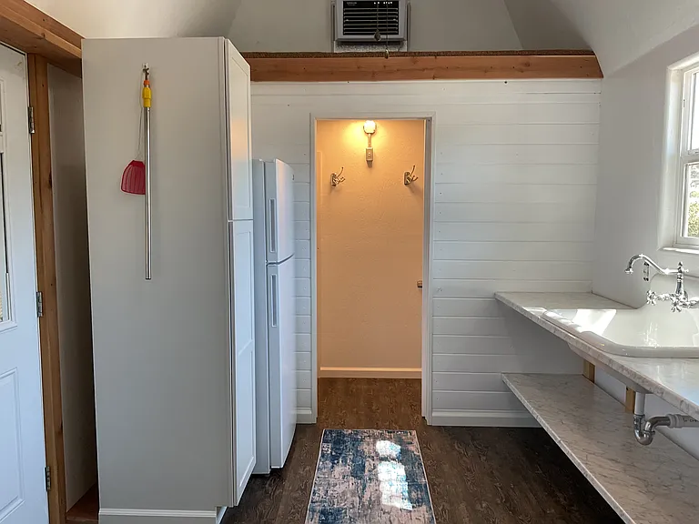 Kitchen with bathroom door open